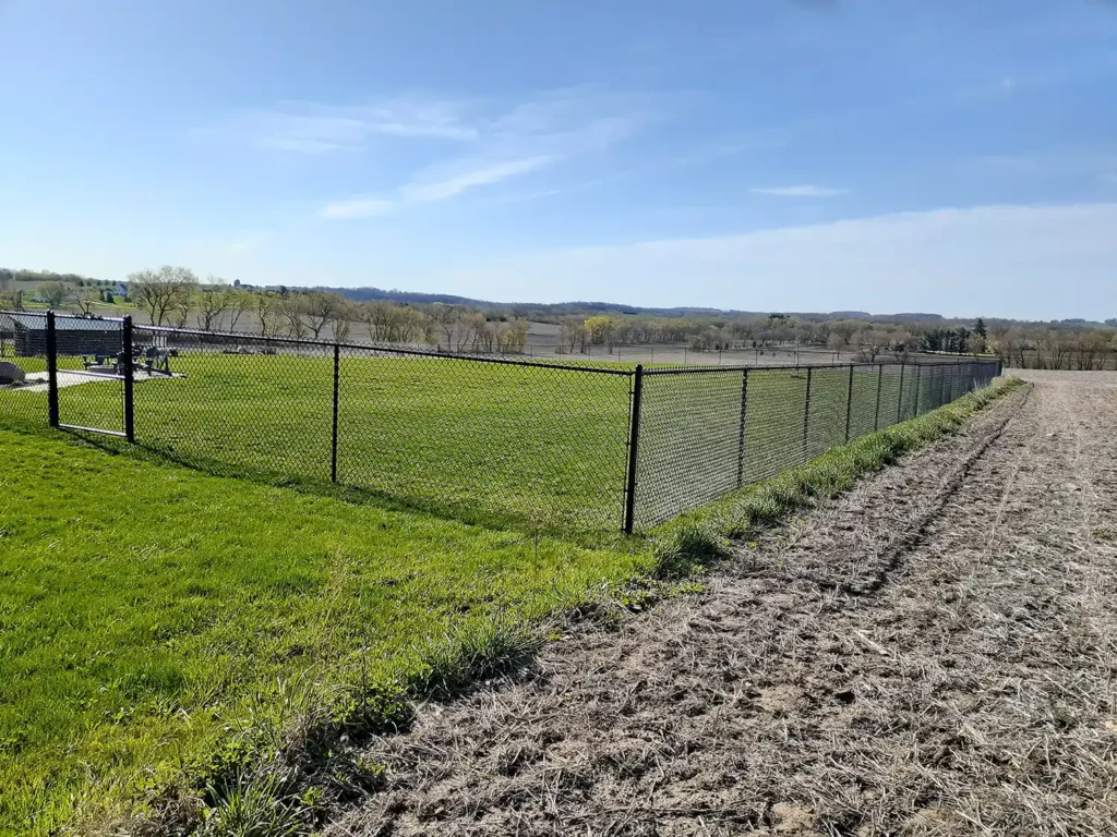 Facing corner of chain link fence in the countryside