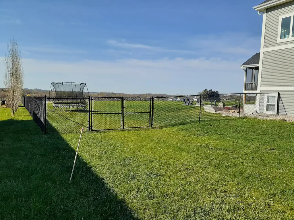VInyl chain link fence with trampoline in the