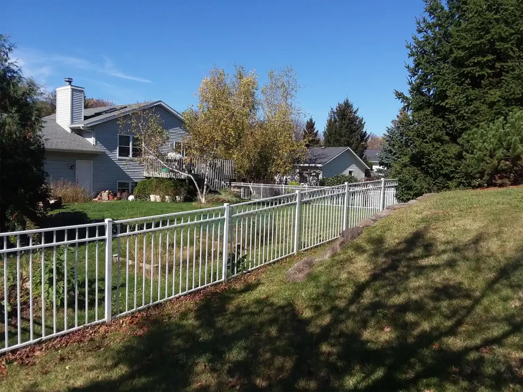 White ornamental steel fence facing the side of the property